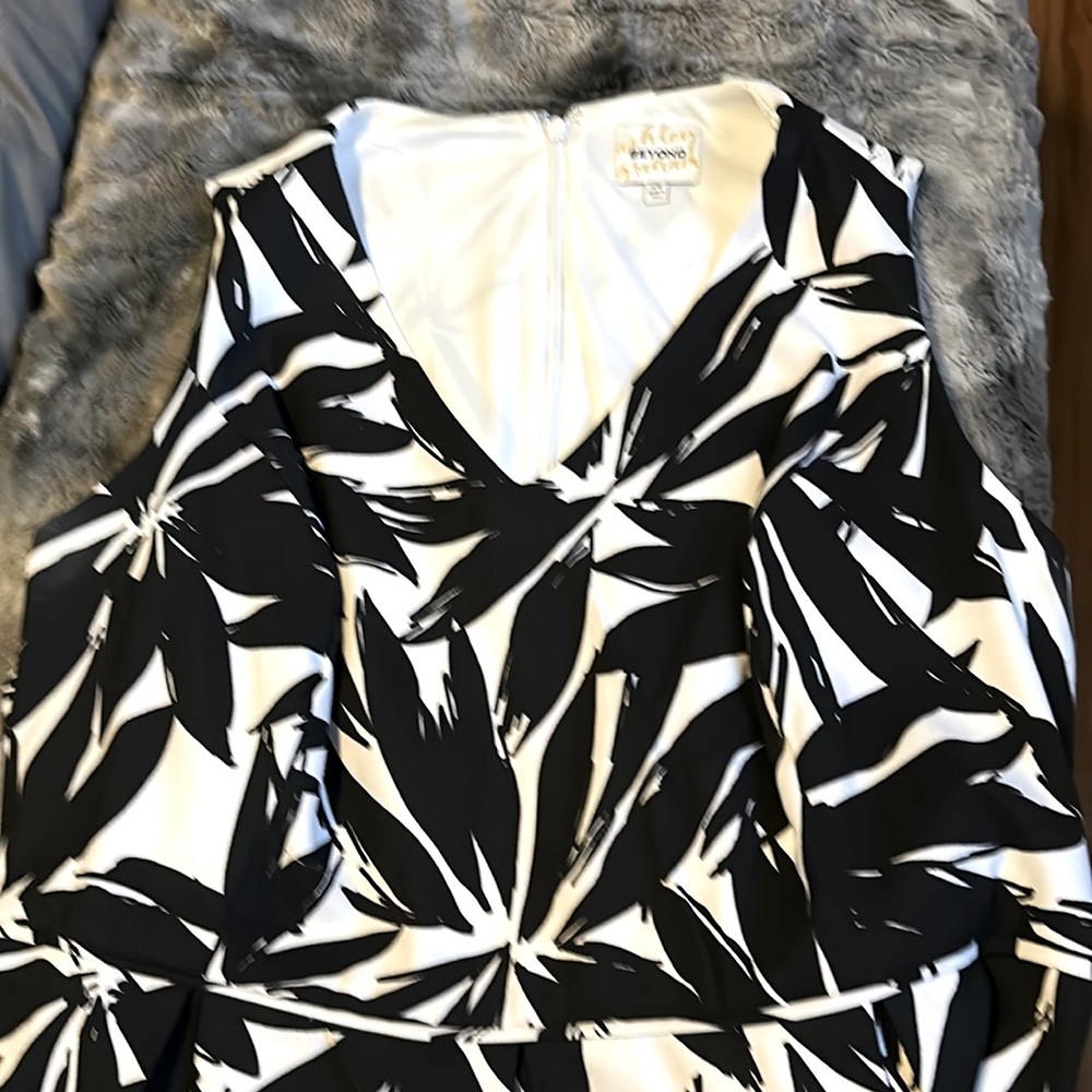 White with black large flowers, wide shoulder straps. Strikingly beautiful fit.